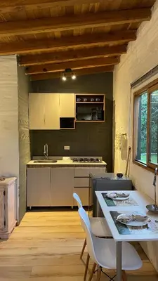 a kitchen with a table and a stove top oven at Ohana in Medellín