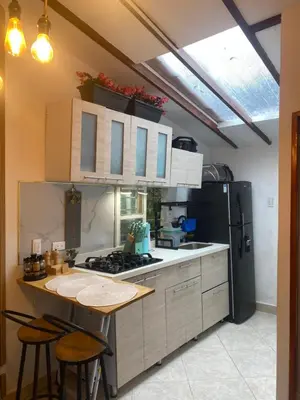 a kitchen with a counter and a refrigerator at Cabernet Cabaña - La Cava Lodge in Medellín