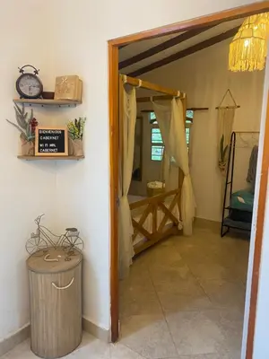 a room with a door open to a room with a table at Cabernet Cabaña - La Cava Lodge in Medellín