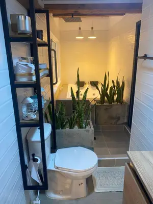 a bathroom with a toilet and plants in it at Cabernet Cabaña - La Cava Lodge in Medellín
