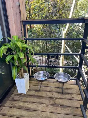 a balcony with two bowls and a potted plant at Cabaña Lambrusco - La Cava Lodge in Medellín