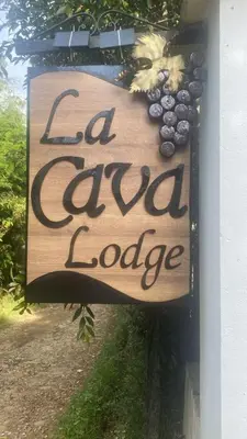 a sign on the side of a building that readscial local lodge at Cabaña Malbec - La Cava Lodge in Medellín