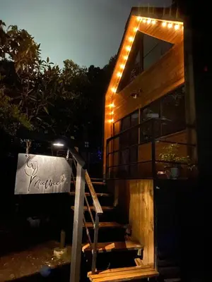 a house with lights on the stairs at night at Cabaña Malbec - La Cava Lodge in Medellín