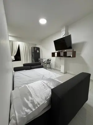 a bedroom with a bed and a flat screen tv at Apartamento cálido in Medellín