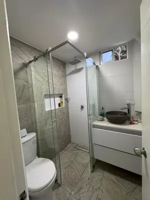 a bathroom with a shower and a toilet and a sink at Apartamento cálido in Medellín