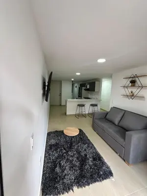 a living room with a couch and a table at Comfortable apartment in Sabaneta in Sabaneta