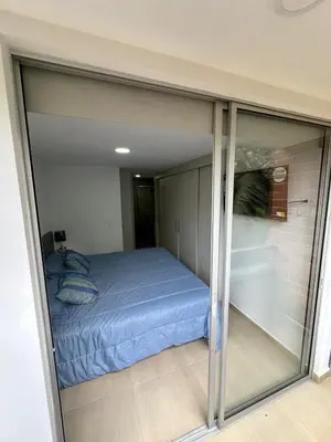 a small bedroom with a bed in a room at Comfortable apartment in Sabaneta in Sabaneta