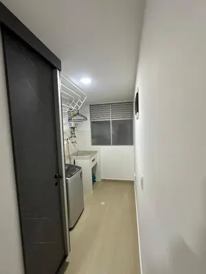 a hallway with a door leading to a kitchen at Comfortable apartment in Sabaneta in Sabaneta