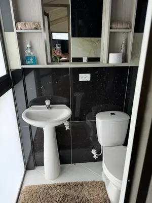 a small bathroom with a sink and a toilet at Countryside house with jacuzzi and Sauna in Jericó