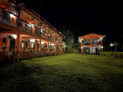 a building with lights on the side of it at night at Countryside house with jacuzzi and Sauna in Jericó