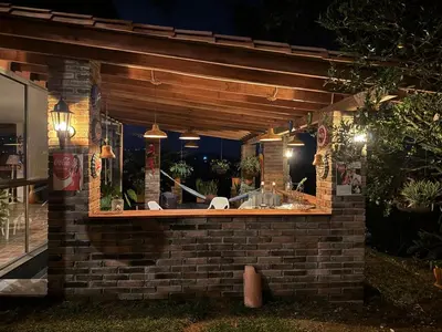 a outdoor bar with a sink in a brick building at Countryside house with jacuzzi and Sauna in Jericó