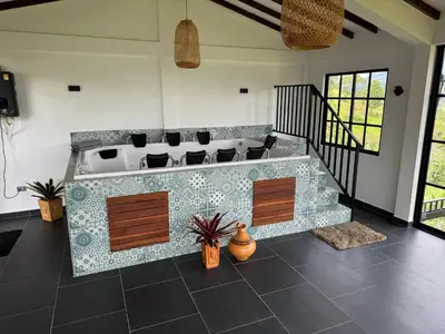 a living room with a tub and chairs in it at Countryside house with jacuzzi and Sauna in Jericó