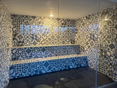 a bathroom with a shower with blue and white tiles at Countryside house with jacuzzi and Sauna in Jericó