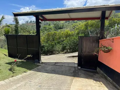 a gate to a house with a roof at Countryside house with jacuzzi and Sauna in Jericó