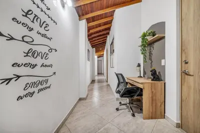 an office with a desk and writing on the wall at Dazzling Apartment con Aire acondicionado in Envigado