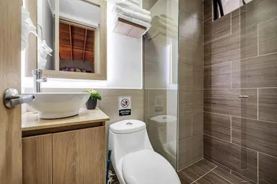 a bathroom with a toilet and a sink and a shower at Dazzling Apartment con Aire acondicionado in Envigado