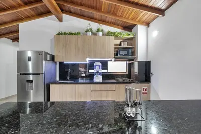 a kitchen with a refrigerator and a counter top at Dazzling Apartment con Aire acondicionado in Envigado