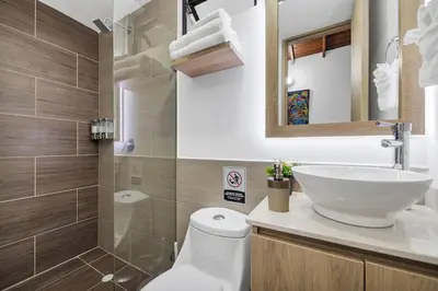 a bathroom with a white toilet and a sink at Dazzling Apartment con Aire acondicionado in Envigado