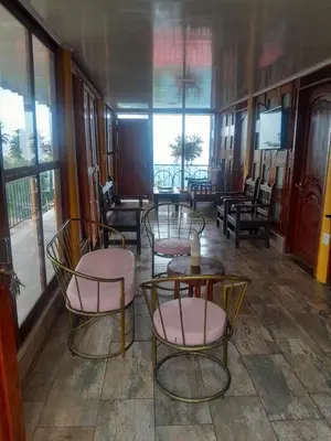 a room with chairs and tables and windows at Perla del Ruiz in Manizales