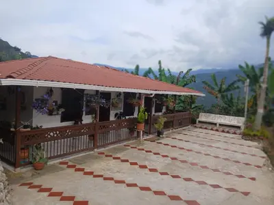 a house with a red roof and a patio at finca nalu in Jardin