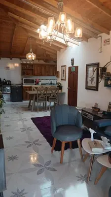 a living room with a blue chair and a table at finca nalu in Jardin