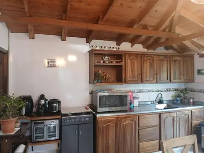 a kitchen with wooden cabinets and a stove top oven at finca nalu in Jardin