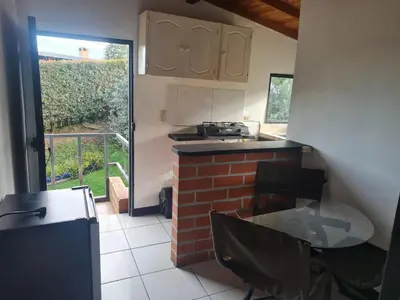 a kitchen with a stove and a counter top at Aparta estudio campestre in Rionegro