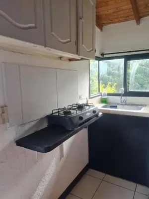 a kitchen with a stove top in a kitchen at Aparta estudio campestre in Rionegro