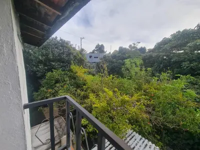 a balcony of a house with trees and bushes at Aparta estudio campestre in Rionegro