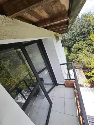 a balcony with sliding glass doors on a house at Aparta estudio campestre in Rionegro
