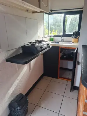 a small kitchen with a stove and a sink at Aparta estudio campestre in Rionegro