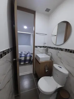 a bathroom with a toilet and a sink and a mirror at Luxury apartment citadela di sole , santafe de antioquia in Santa Fe de Antioquia