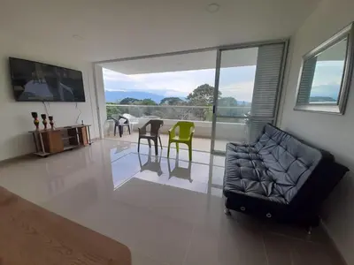a living room with a couch and a table and chairs at Luxury apartment citadela di sole , santafe de antioquia in Santa Fe de Antioquia