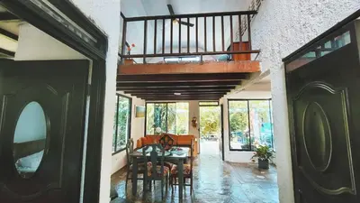 a dining room with a table and a balcony at cabaña in Honda