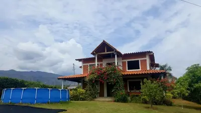 a house with a blue object in front of it at Hermosa Casa Familiar in Santa Fe de Antioquia