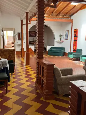 a living room with a large room with a fireplace at La casa de la abuela in Jericó