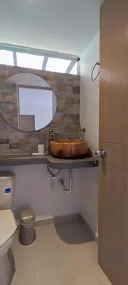 a bathroom with a sink and a toilet and a mirror at habitación campestre para pareja JAZMIN in Jardin