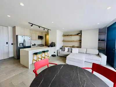 a kitchen and a living room with a table and chairs at The best location in Poblado Air conditioning in Medellín