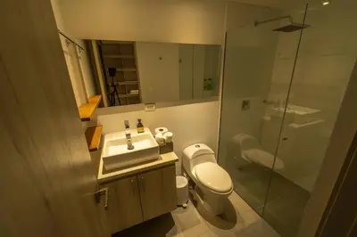 a bathroom with a toilet and a sink and a shower at The best location in Poblado Air conditioning in Medellín