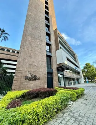 a building with a clock tower in front of it at The best location in Poblado Air conditioning in Medellín