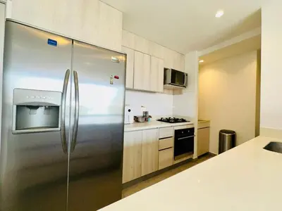 a kitchen with a stainless steel refrigerator at The best location in Poblado Air conditioning in Medellín