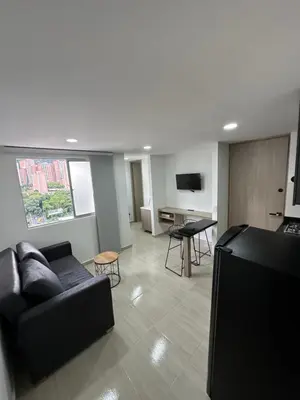 a living room with a couch and a table at céntrico y acogedor apartamento in Sabaneta