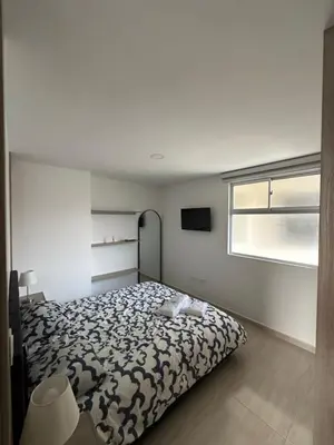 a bedroom with a bed and a window at céntrico y acogedor apartamento in Sabaneta