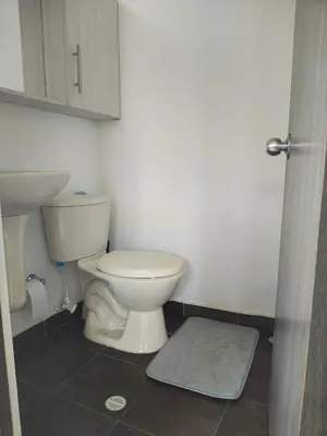 a bathroom with a toilet and a sink at Apto 2 zona rosa sector la 70 estadio in Medellín