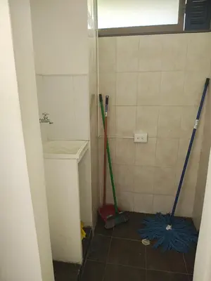 a bathroom with two shovels in the corner of a room at Apto 2 zona rosa sector la 70 estadio in Medellín