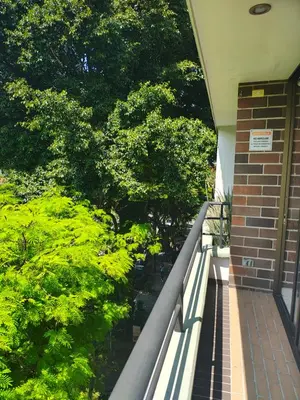 a balcony of a building with trees on it at Apto 2 zona rosa sector la 70 estadio in Medellín