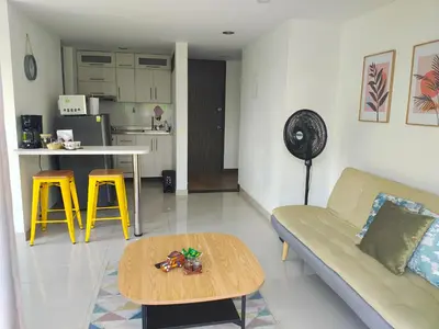 a living room with a couch and a table at Apto 2 zona rosa sector la 70 estadio in Medellín