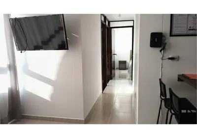 a hallway with a flat screen tv on a wall at Apartamentos Nuevos 2 y 3 habitaciones 6 personas - Cerca a Expoferias y Bosque Popular, Cable Aereo in Manizales