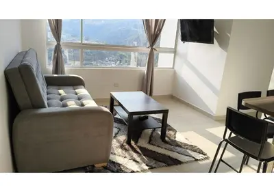 a living room with a couch and a table at Apartamentos Nuevos 2 y 3 habitaciones 6 personas - Cerca a Expoferias y Bosque Popular, Cable Aereo in Manizales