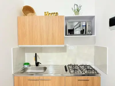 a kitchen with a sink and a microwave at Casa Bendita 201 Espectacular in Medellín